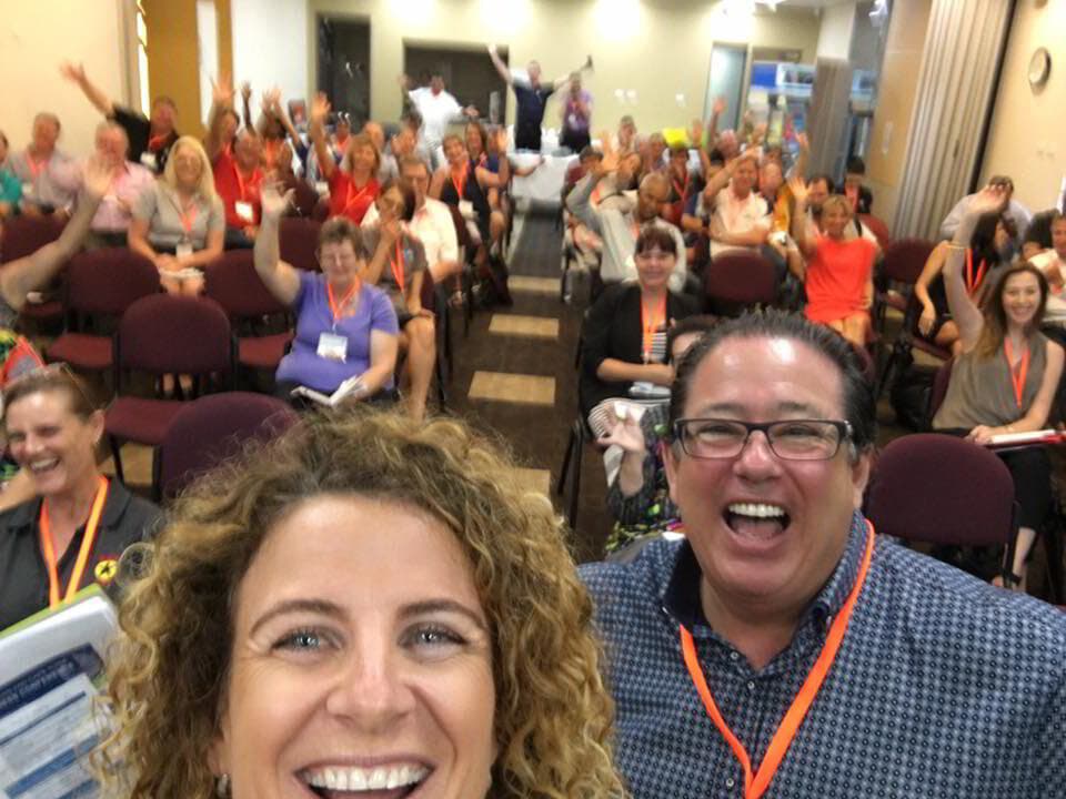 Lisa Monks taking a selfie with a big, happy audience at one of her training events