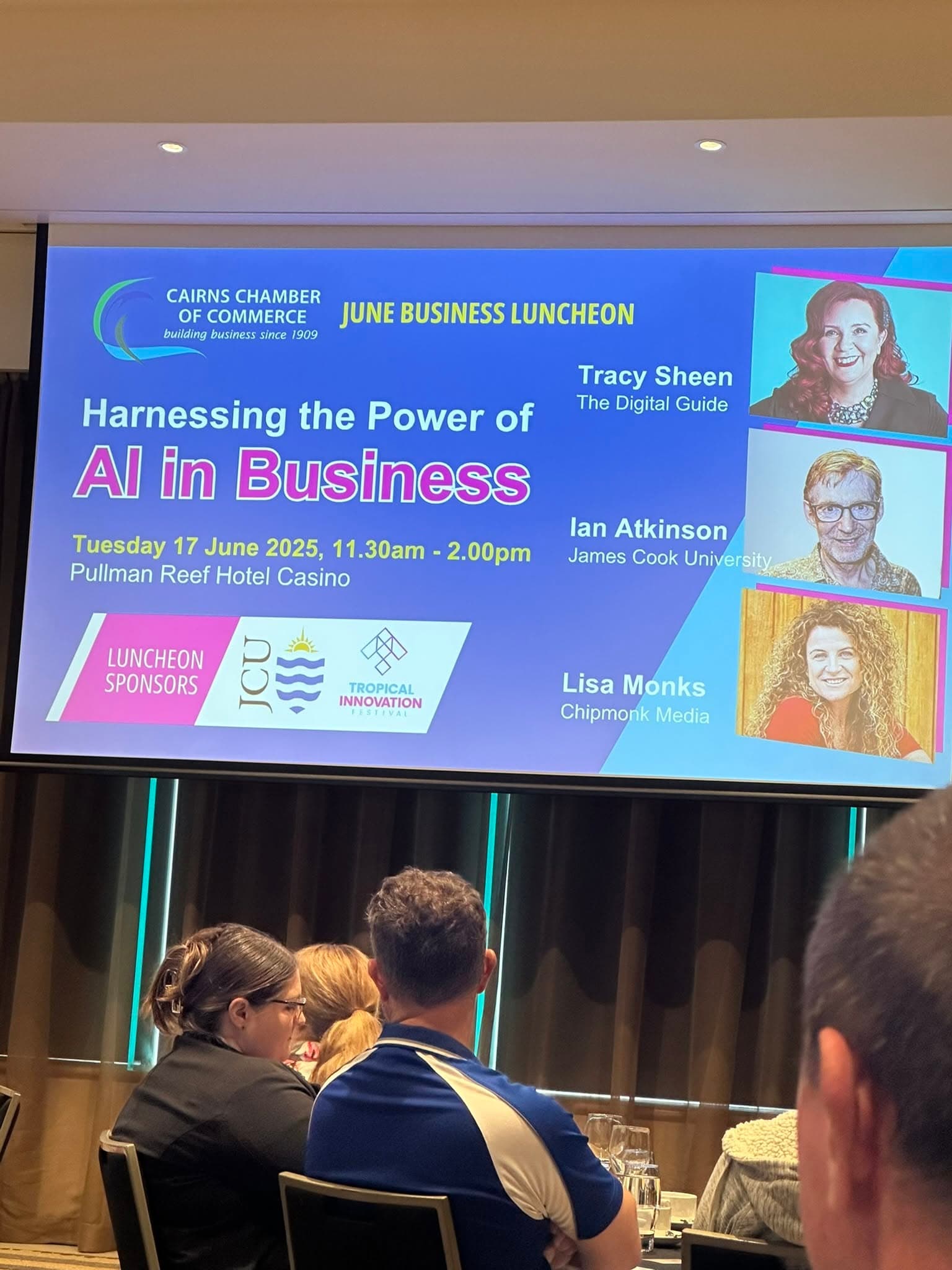 The big screen at the Cairns Chamber of Commerce June Business Luncheon showing the 'Harnessing the Power of AI in Business' speaker line-up, with Lisa Monks of ChipMonk Media among the speakers